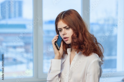 woman talking on cell phone in office © SHOTPRIME STUDIO