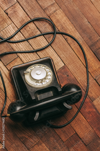 black telephone, retro, wire on a wooden background