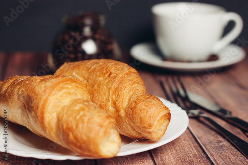 croissants, cutlery, coffee cup