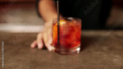 Bartender serving negroni