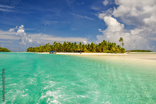 Stunning view of a beach on One Foot Island, also called Tapuaetai, in the lagoon of Aitutaki, Cook Islands, in the South Pacific Ocean. Clear water, palm trees and white sand beach on a sunny day.  photo