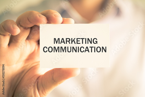 Businessman holding MARKETING COMMUNICATION message card