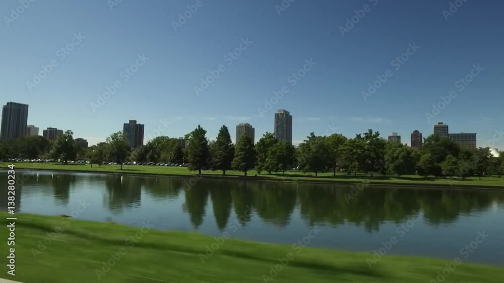 Driving by a small lake with buildings in the background in Chicago. Driving by a small lake with buildings in the background in Chicago.