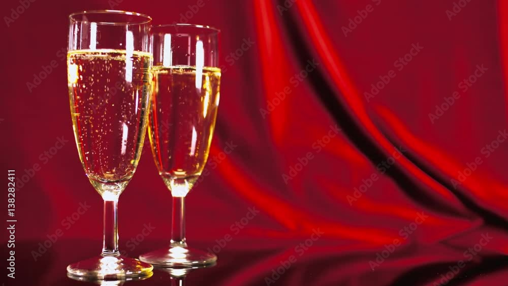 Glasses of Champagne on red velvet - beautiful scene Glasses of Champagne on red velvet - beautiful scene