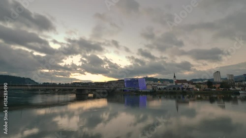 The sun sets on the Danube River in time lapse in Linz, Austria