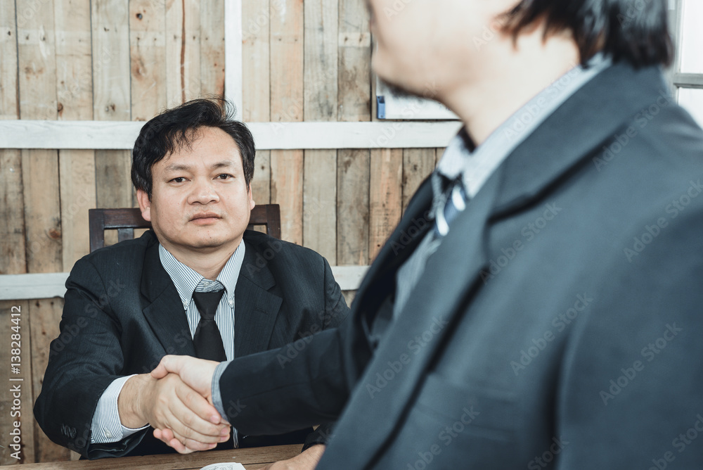 Two business people shaking hands During the negotiations business partnerships successful. Two business people shaking hands During the negotiations business partnerships successful.