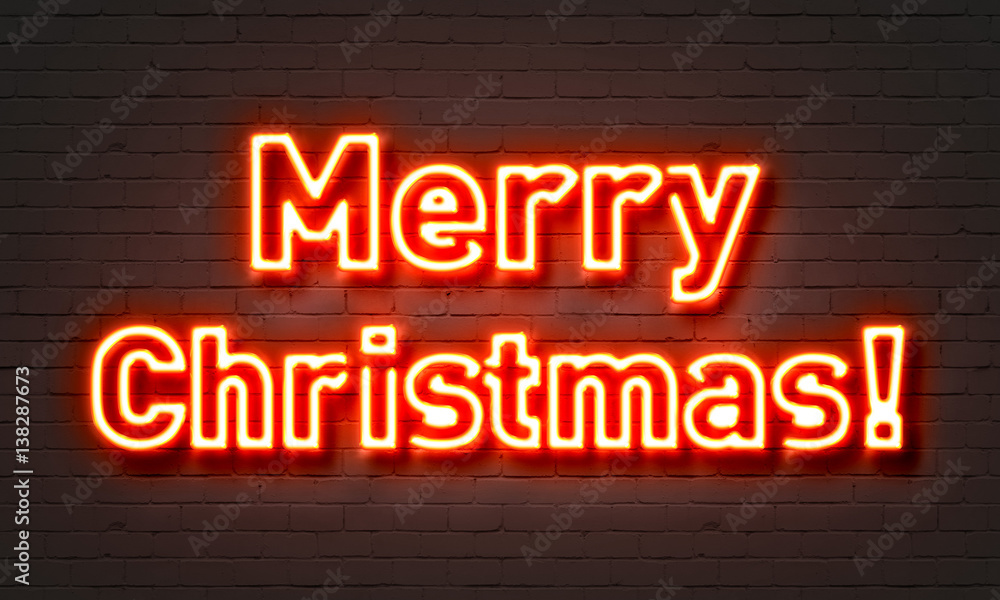 Merry Christmas neon sign on brick wall background.