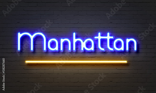 Manhattan neon sign on brick wall background.