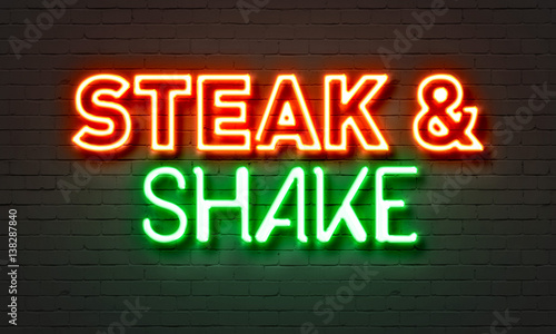 Steak & shake neon sign on brick wall background.