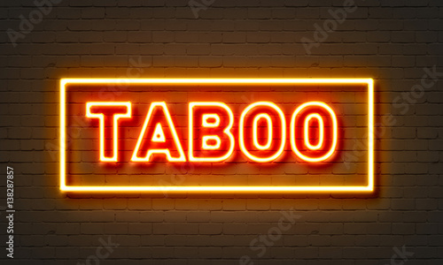 Taboo neon sign on brick wall background. photo