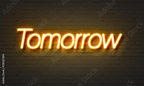 Tomorrow neon sign on brick wall background.