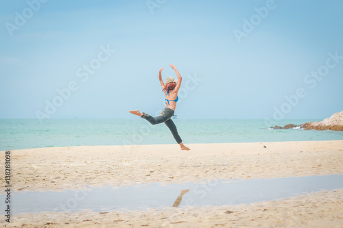 girl jump on  the beach, happy on vacation time