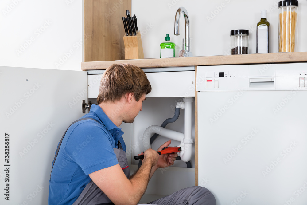 Male Plumber Fixing Sink Pipe Male Plumber Fixing Sink Pipe