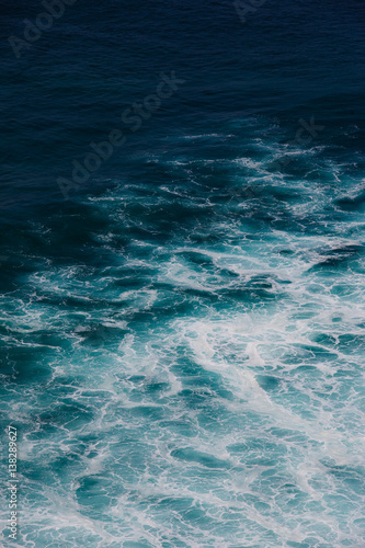 Indian ocean texture. Turquoise sea water with white foam. Powerful and peaceful nature concept.