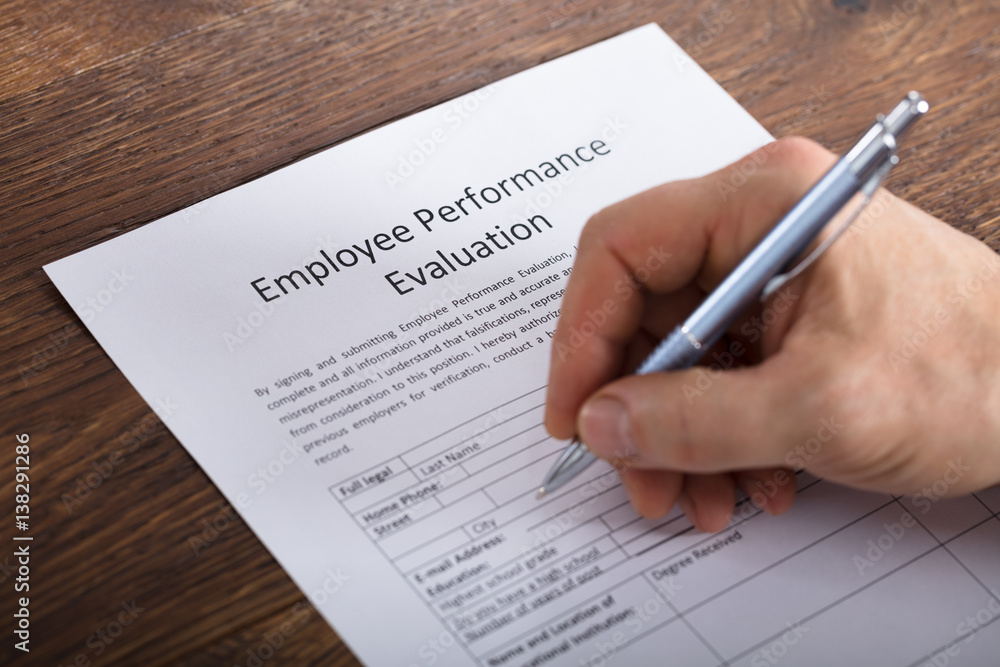 Person Filling A Performance Evaluation Form Person Filling A Performance Evaluation Form