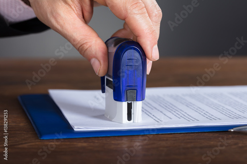 Person's Hand Stamping Document