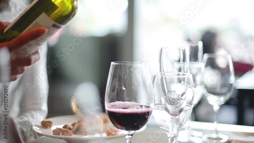 Close-up of red wine being poured into glass in restaurant
