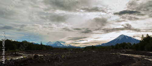 View of volcanoes: Ostry Tolbachik, Klyuchevskaya Sopka, Bezymianny, Kamen from river Studenaya at dawn. Kamchatka Peninsula. photo