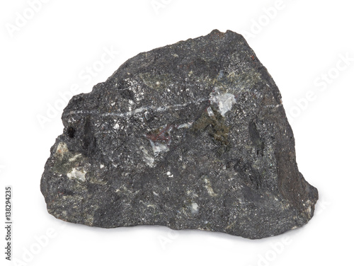 Mineral  magnetite isolated on white background. Magnetite is a mineral and one of the main iron ores. Magnetite is ferrimagnetic  it is attracted to a magnet and can be magnetized.