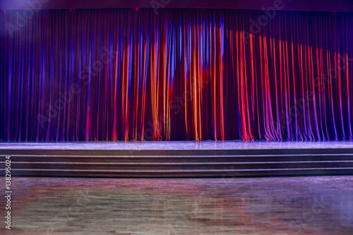 Red curtains and wooden stage.