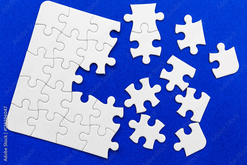 Naklejka premium White puzzle elements on a blue background. 