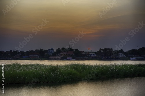 Sunset behind waterfront homes.