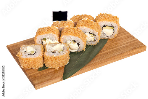 Sushi rolls on wooden Board with leaves of leeks and black sign for logo and name