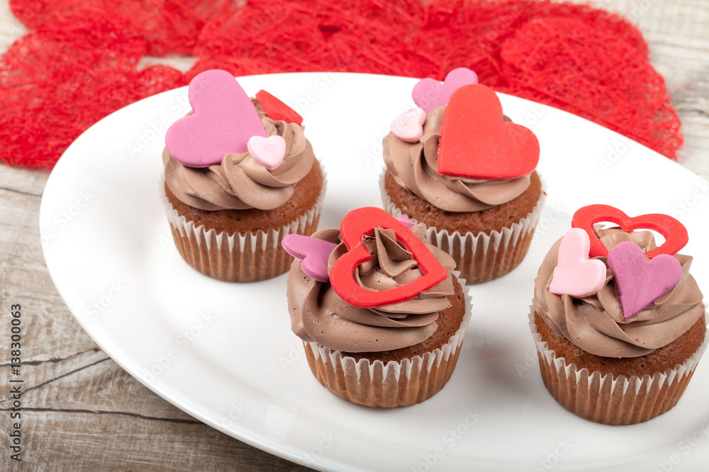 Cupcakes with cream decorated with heart