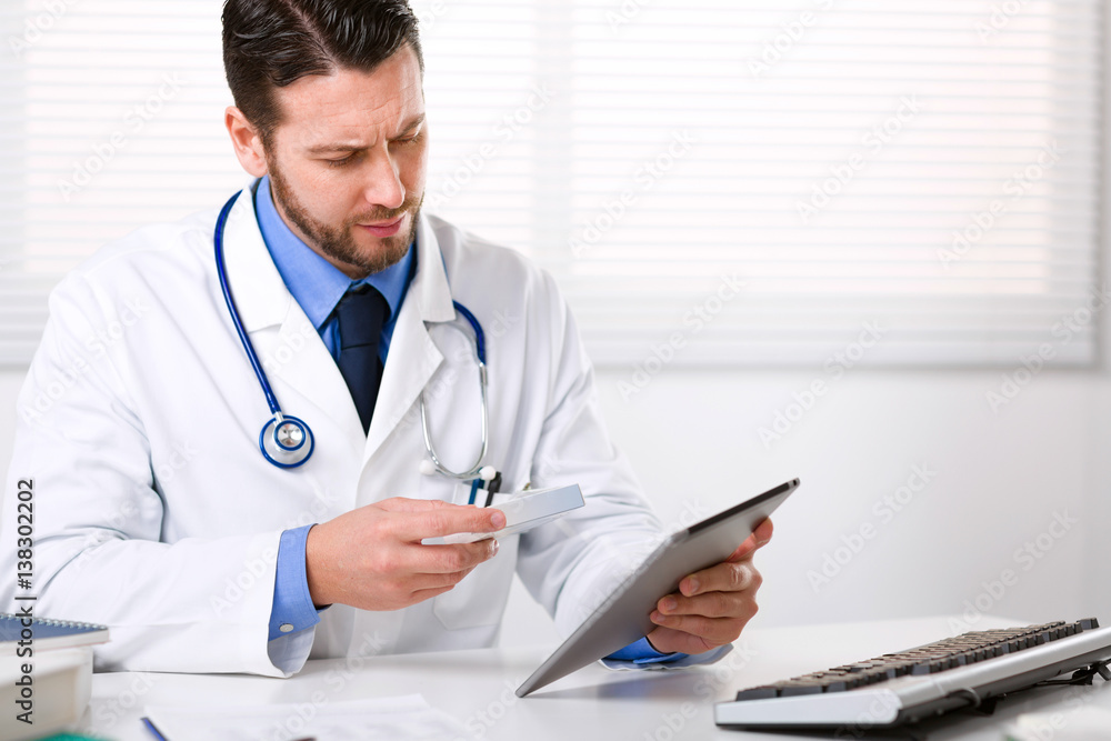 Doctor holding tablet and the box of medicine Doctor holding tablet and the box of medicine