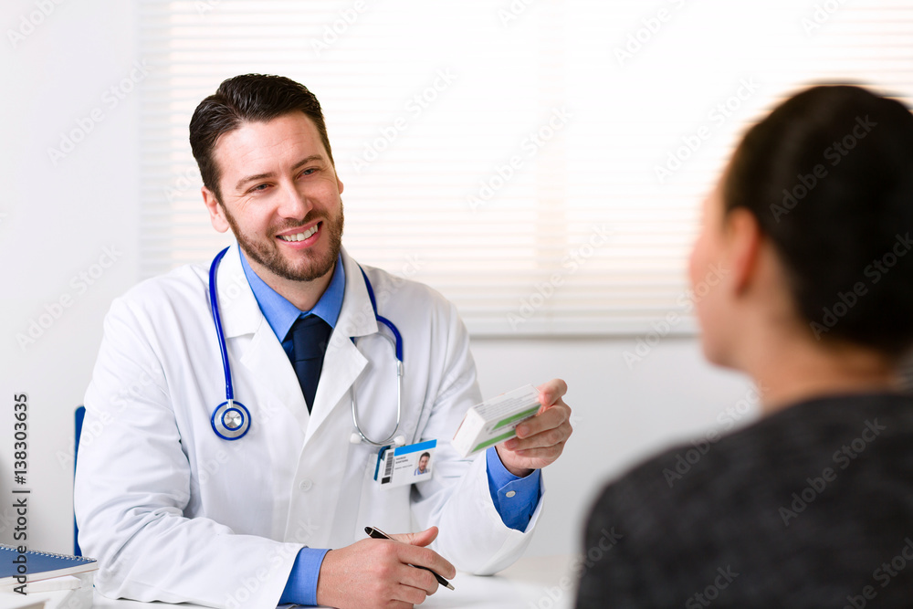 Doctor smiling looking at patient Doctor smiling looking at patient