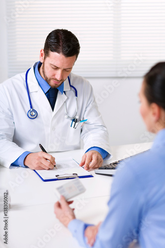 Doctor writing prescription