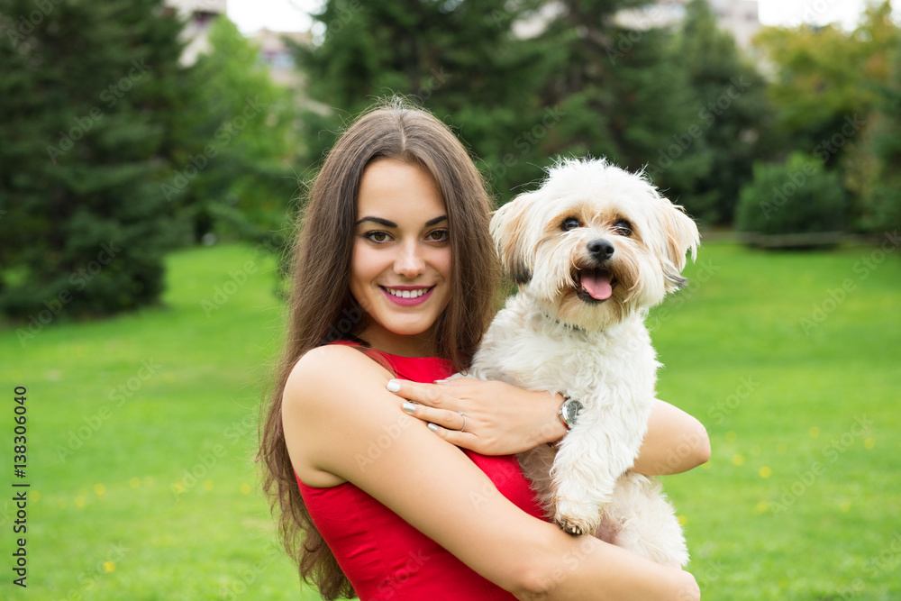 Girl with puppy. Portrait of attractive happy smiling young woman holding cute little dog, summer park outdoor. Girl with puppy. Portrait of attractive happy smiling young woman holding cute little dog, summer park outdoor.