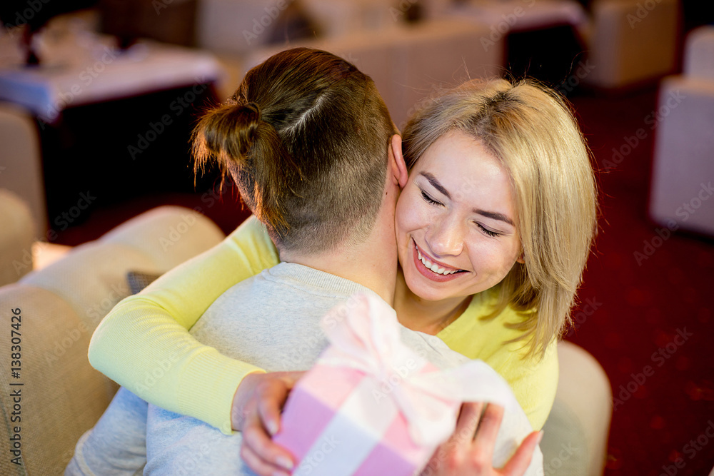 young man gives a gift to the girlfriend young man gives a gift to the girlfriend