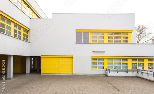 White Building Facade with Yellow Window Frames photo