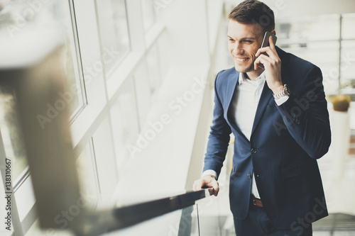 Handsome businessman using ...