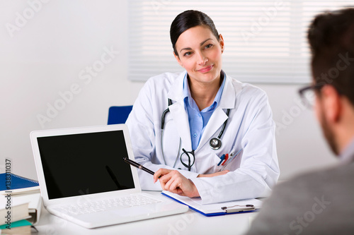 Female doctor listening intently to a patient