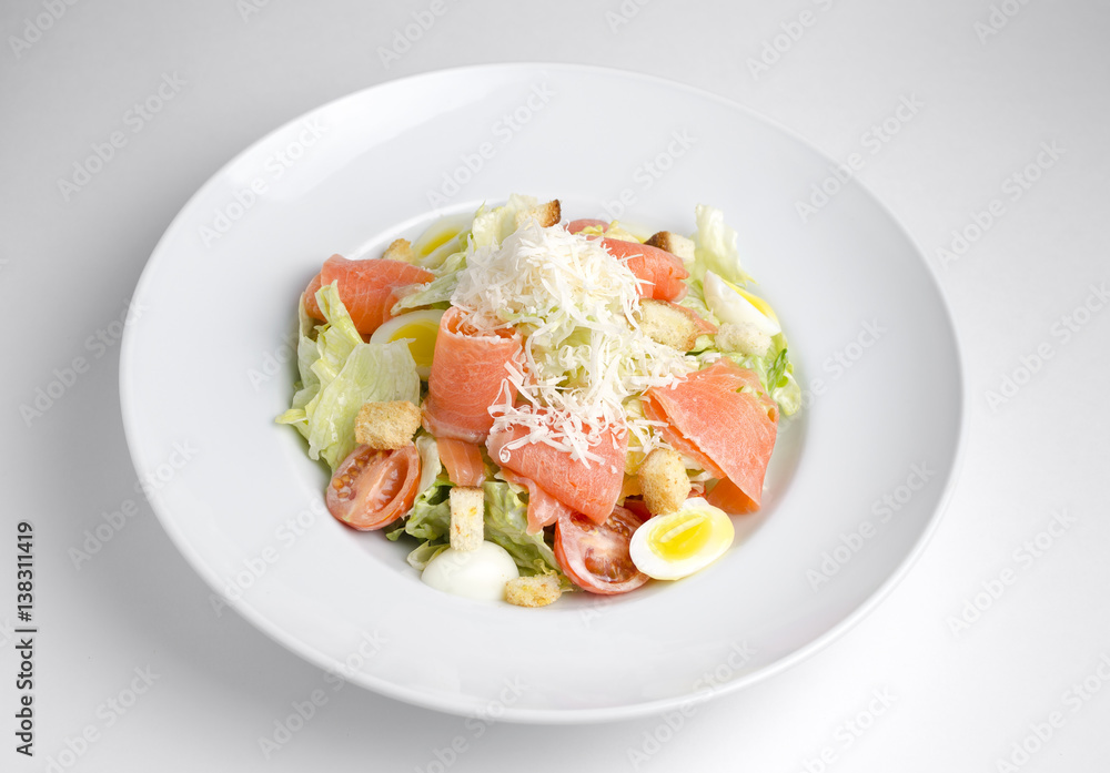 Salad with marinated salmon on a white plate Salad with marinated salmon on a white plate