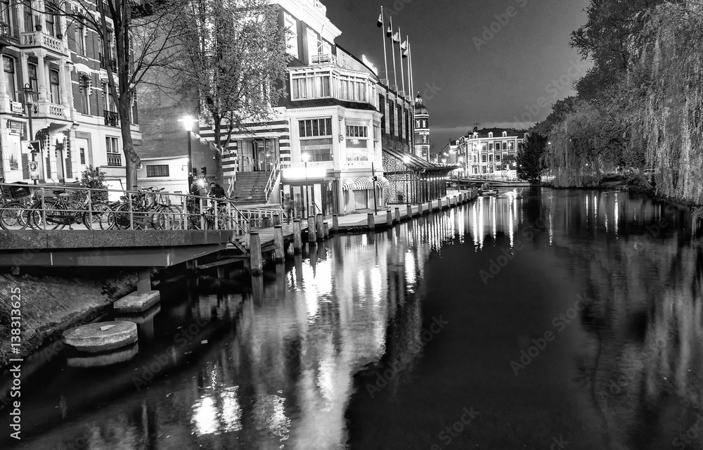 AMSTERDAM - MAY 1, 2013: City canals at night for Queen's Day. Amsterdam attracts 10 million visitors every year