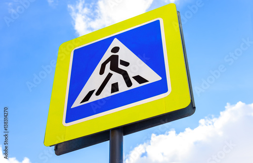 Traffic sign pedestrian crossing against the blue sky background