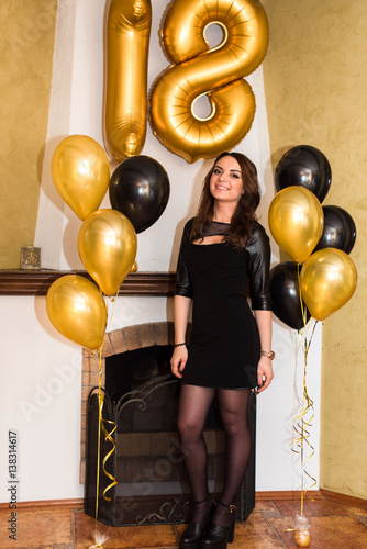 a birthday girl on her 18th birthday with baloons