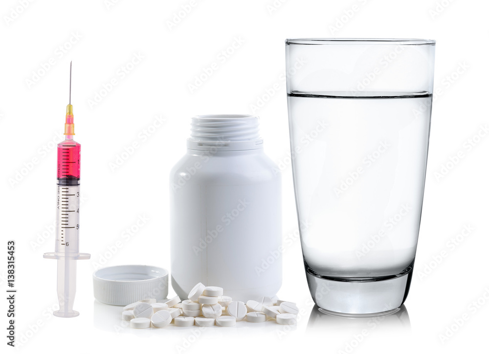 Pills spilling out of pill bottle and Glass of water
