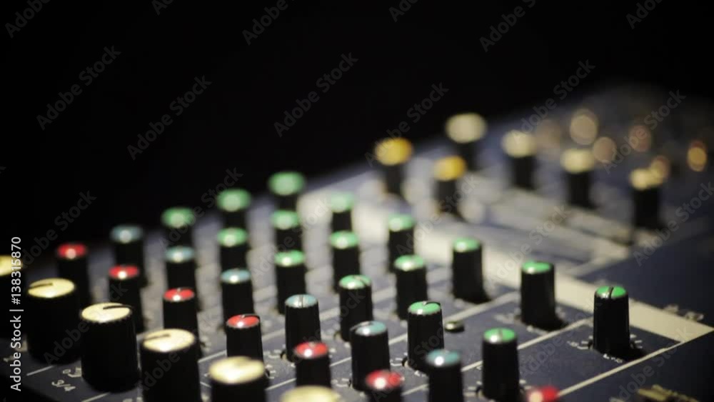 Vertical dolly shot video of a mixer desk with many buttons. Vertical dolly shot video of a mixer desk with many buttons.