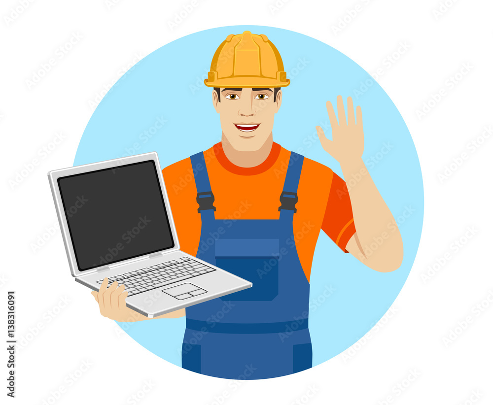 Builder with laptop greeting someone with his hand raised up Builder with laptop greeting someone with his hand raised up