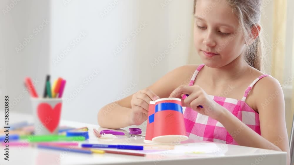 Seven years old girl makes paper toy. Seven years old girl makes paper toy.