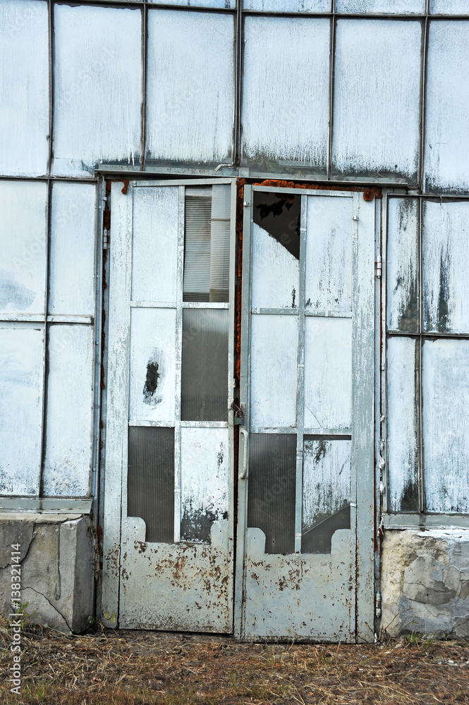 Door of abandoned greenhouse