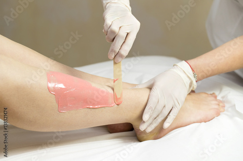 Process depilation female legs and hands in a beauty salon 