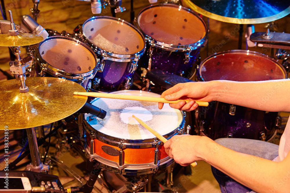Obraz premium The drummer in action. A photo close up process play on a musical instrument