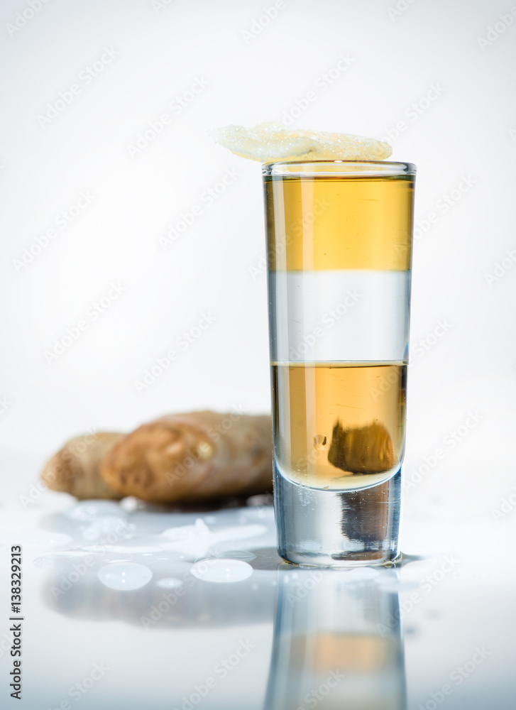alcohol cocktail shot on a light background with reflection alcohol cocktail shot on a light background with reflection