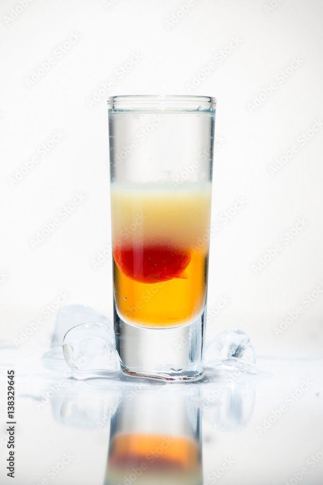 alcohol cocktail shot on a light background with reflection alcohol cocktail shot on a light background with reflection