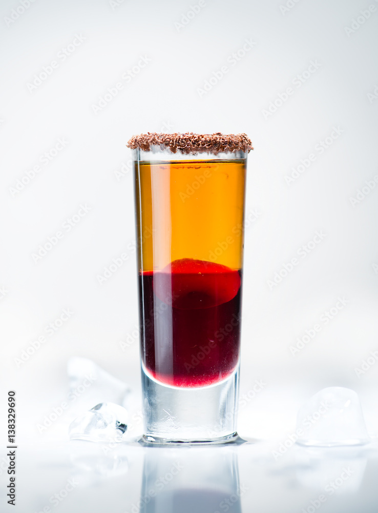 alcohol cocktail shot on a light background with reflection alcohol cocktail shot on a light background with reflection